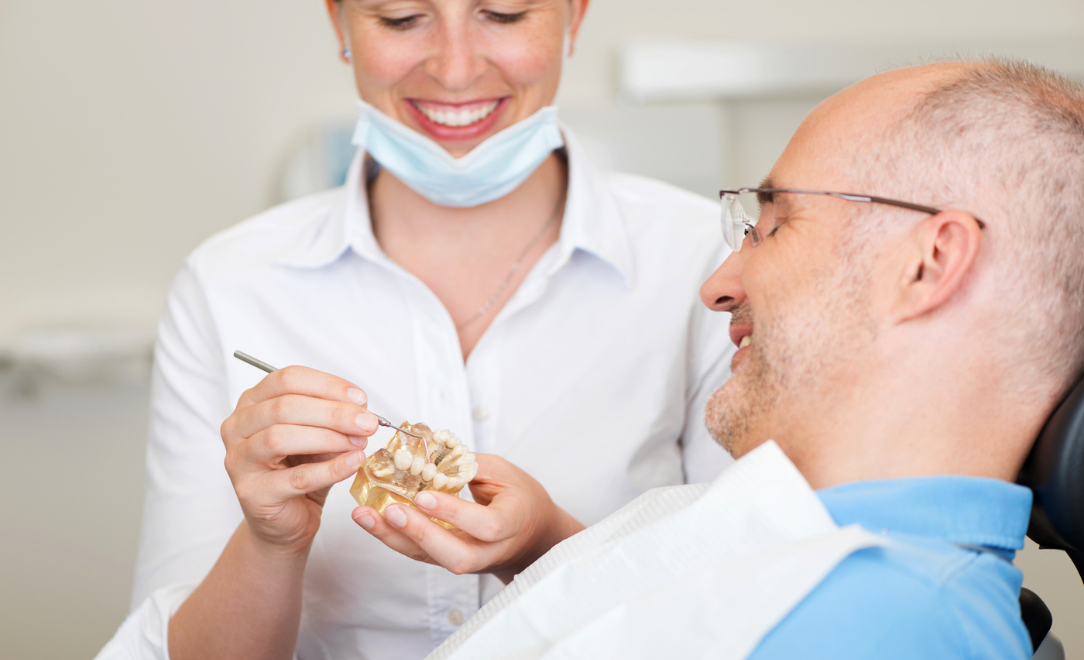 dental implant dentist showing patient how dental implants work